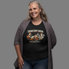 Woman wearing a black t-shirt with 'Track Day Crew' graphic design on a gray background