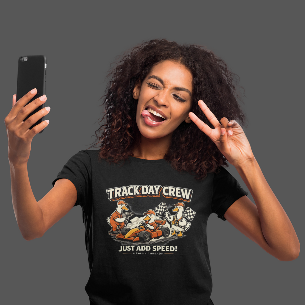 Woman wearing a 'Track Day Crew' t-shirt and taking a selfie.