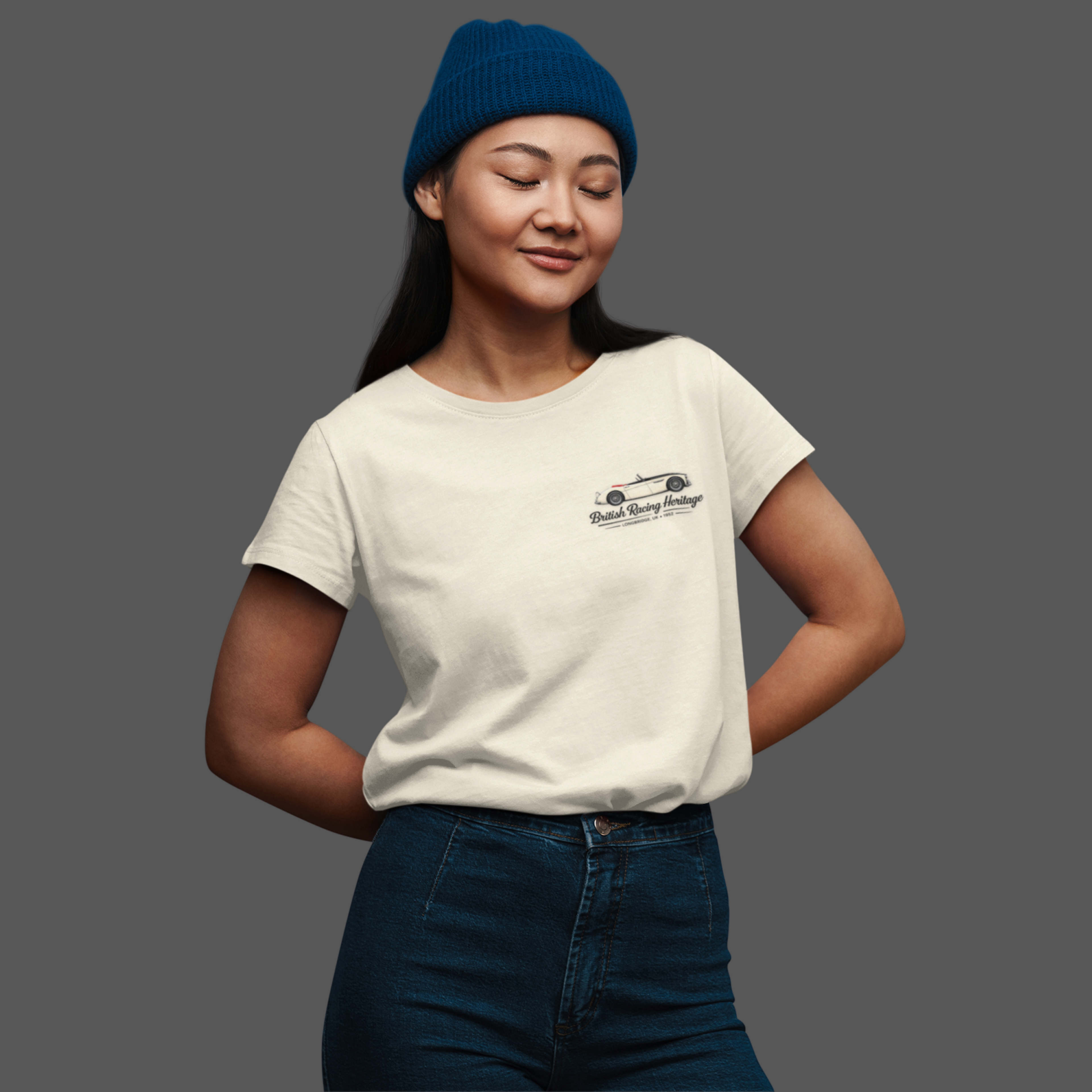Girl wearing a white t-shirt with a Healey classic car graphic design on a gray background