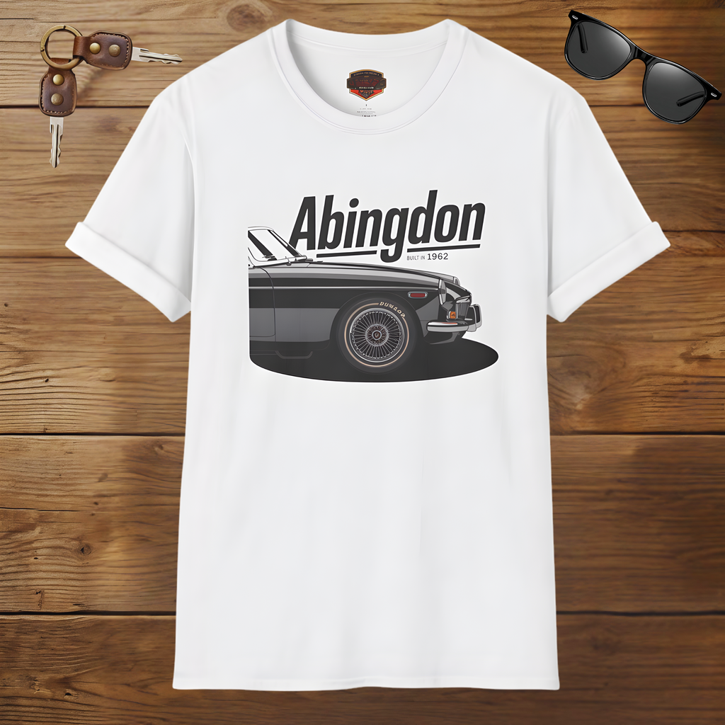 White t-shirt with a classic car graphic and 'Abingdon' text on a wooden surface with sunglasses and keys.