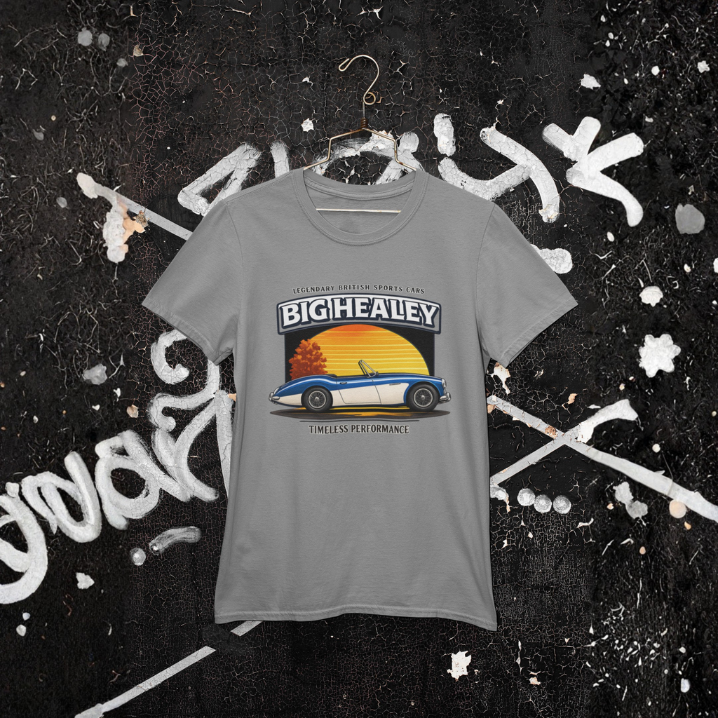 Big Healey graphic gray colored t-shirt featuring a blue and white Austin Healey roadster with retro sunset artwork and vintage British sports car hanging against a wall.