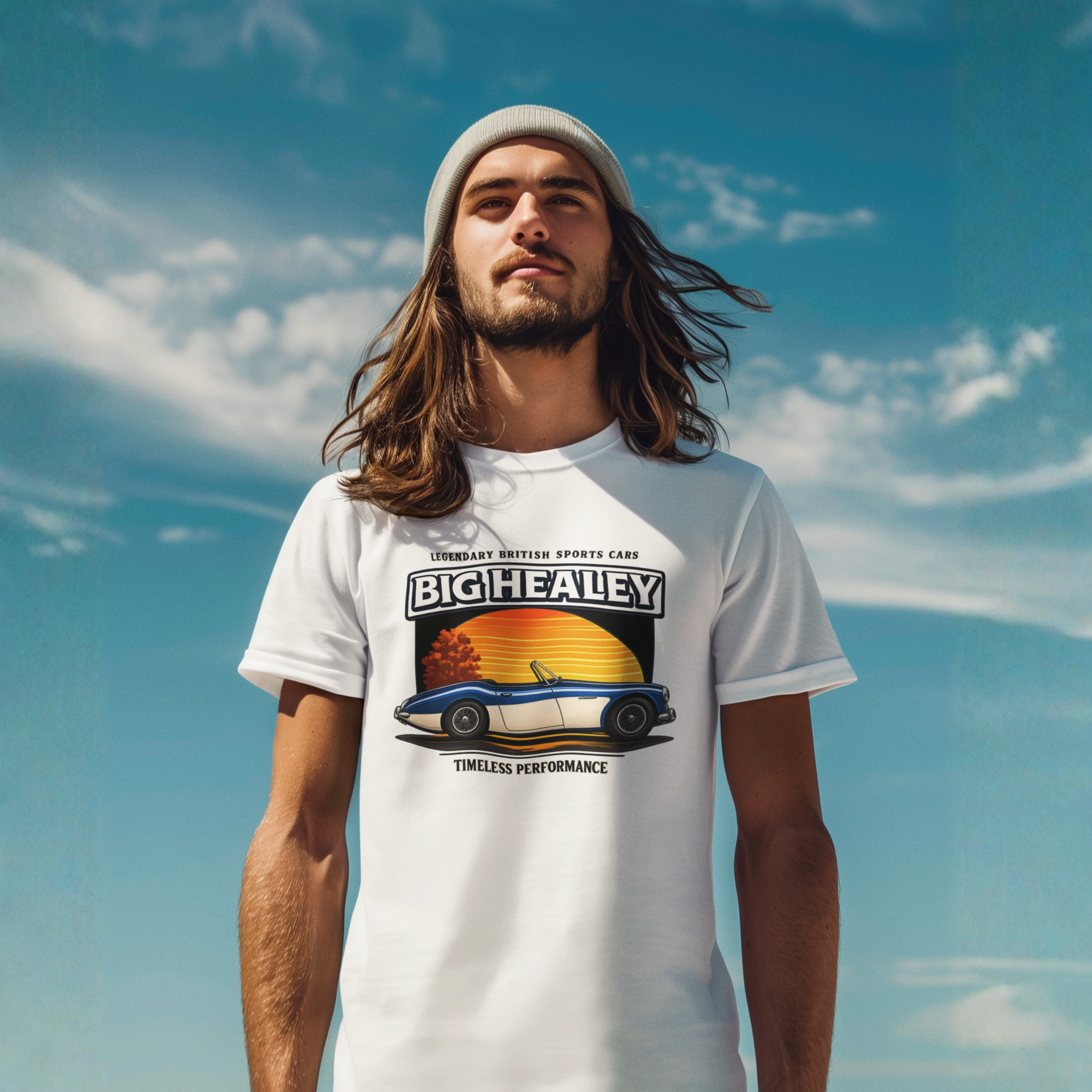  Man wearing a Big Healey graphic white colored t-shirt featuring a blue and white Austin Healey roadster with retro sunset artwork and vintage British sports car on a blue sky background