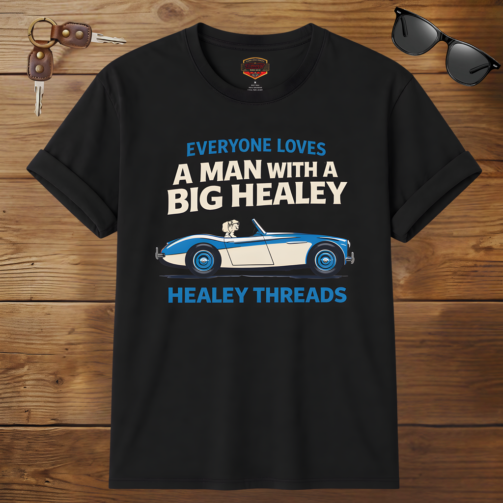Black t-shirt with car graphic and text on a wooden surface