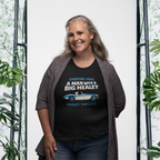 Woman wearing a black t-shirt with a Healey graphic and text, standing in front of a white background with plants.