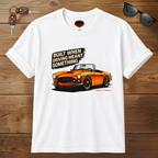 White t-shirt with orange car graphic and text on a wooden surface with sunglasses and keys.