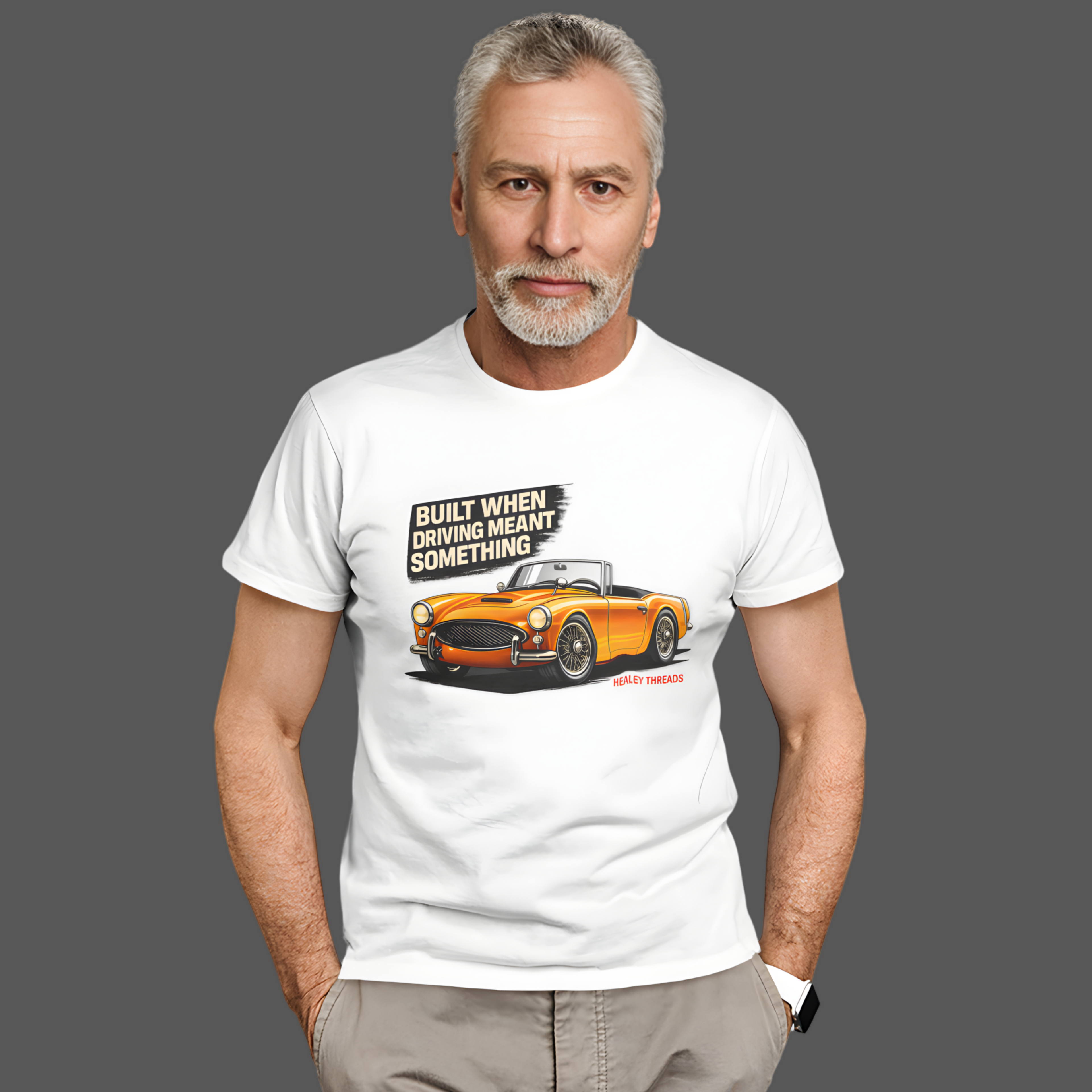 Man wearing a white t-shirt with a graphic of an orange car and text on a gray background