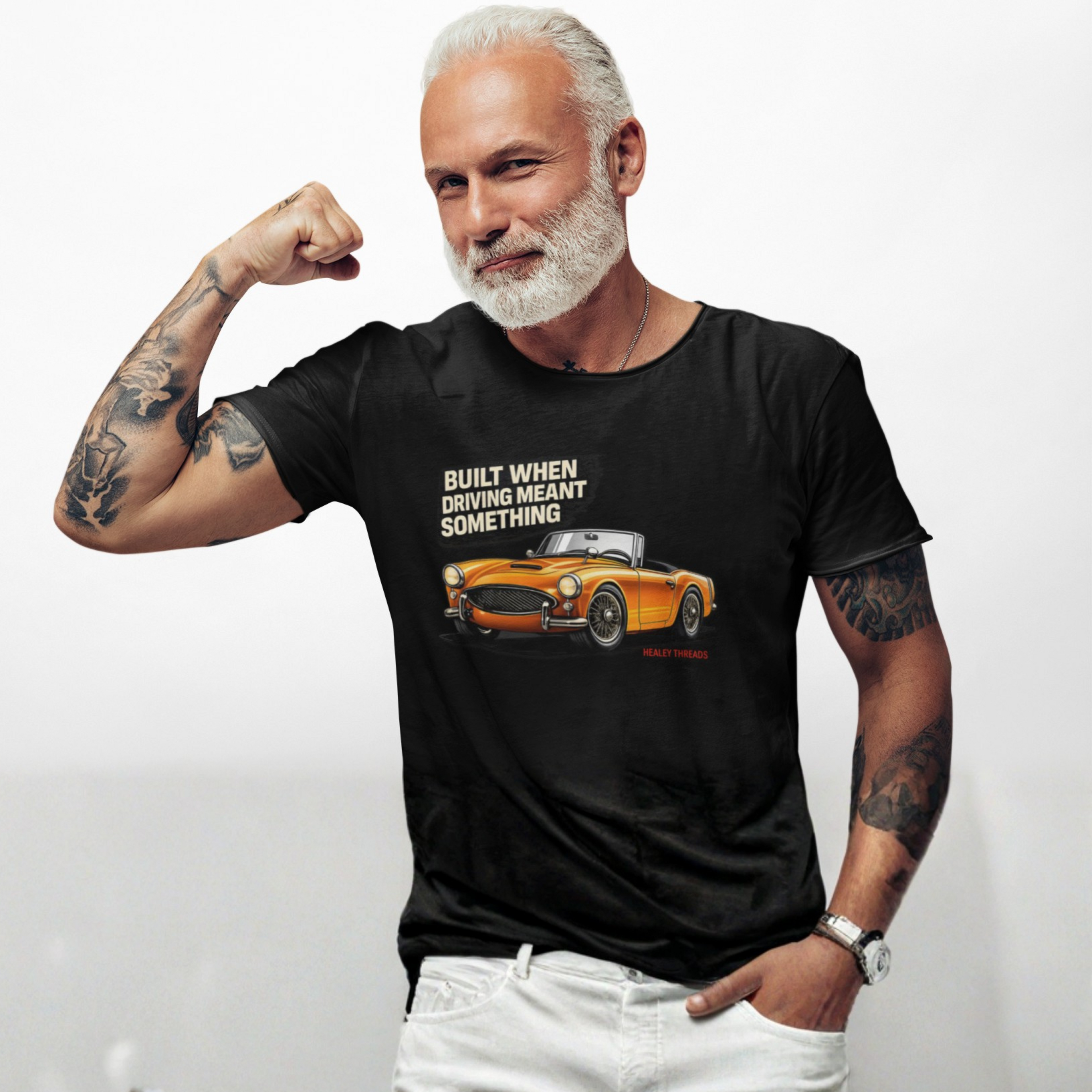 Man wearing a black t-shirt with a graphic and text, flexing his arm on a white background
