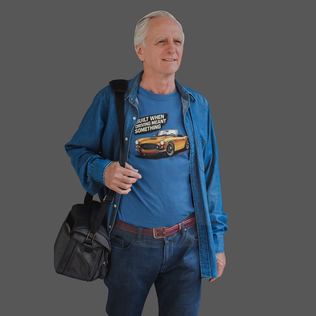 Man wearing a royal blue shirt with a graphic design, holding a black bag on a gray background