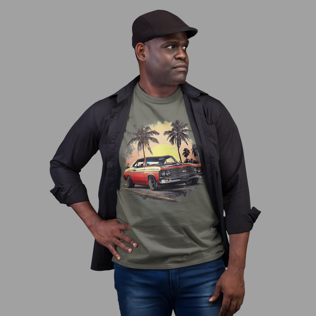 Man wearing a military green t-shirt with a graphic design of a classic car and palm trees, standing against a plain background.
