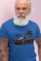Man wearing a royal blue t-shirt with 'American Muscle' graphic design against a pink background