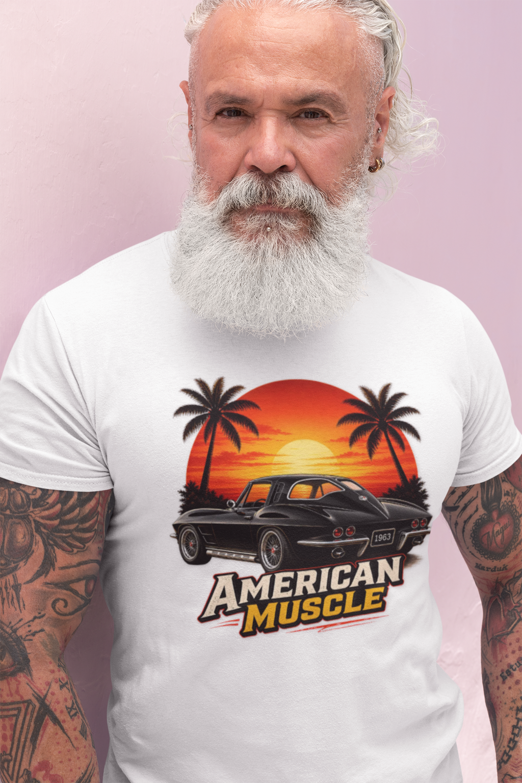 Man wearing a white t-shirt with 'American Muscle' graphic design on a pink background