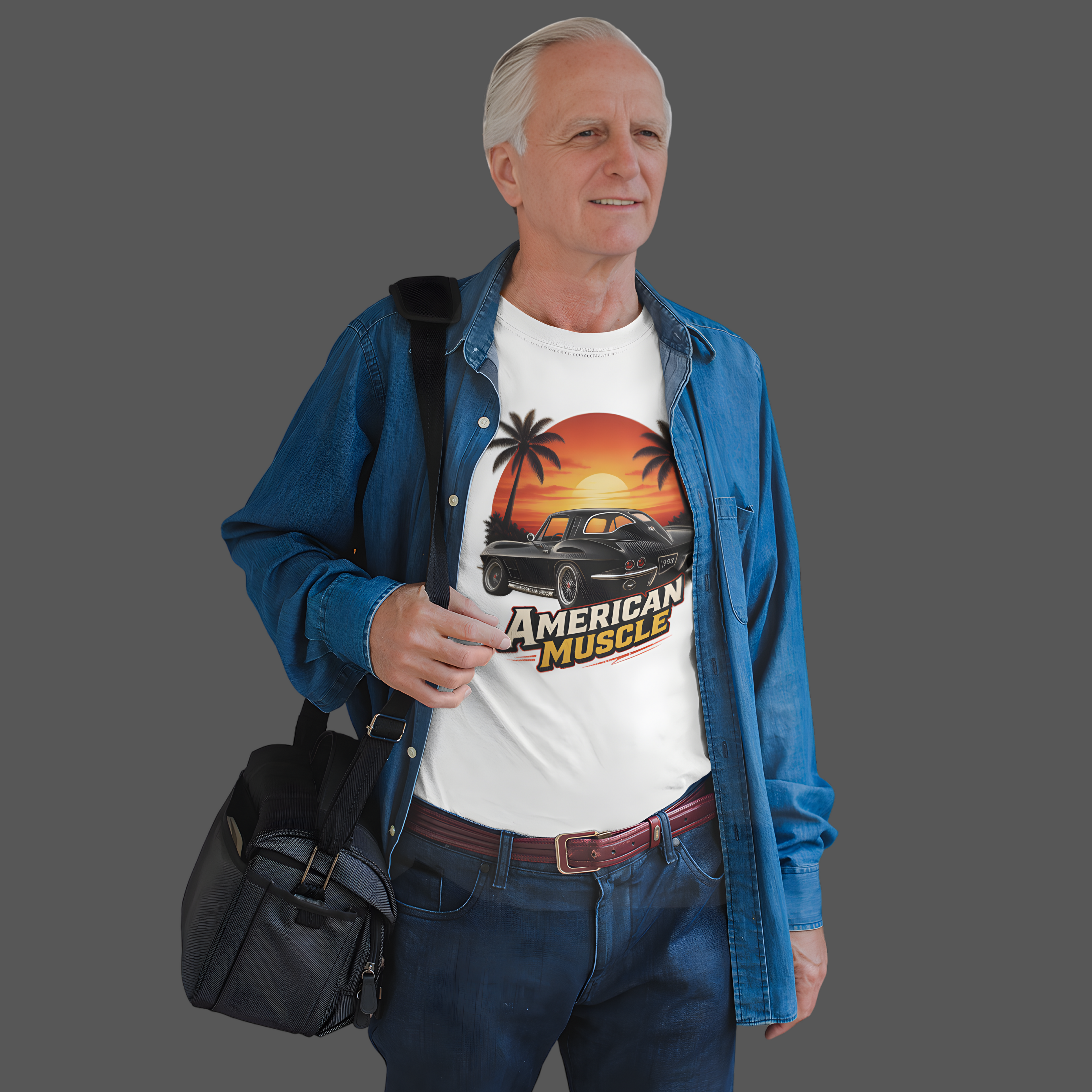 Man wearing a white t-shirt with 'American Muscle' graphic design, holding a black bag on a gray background