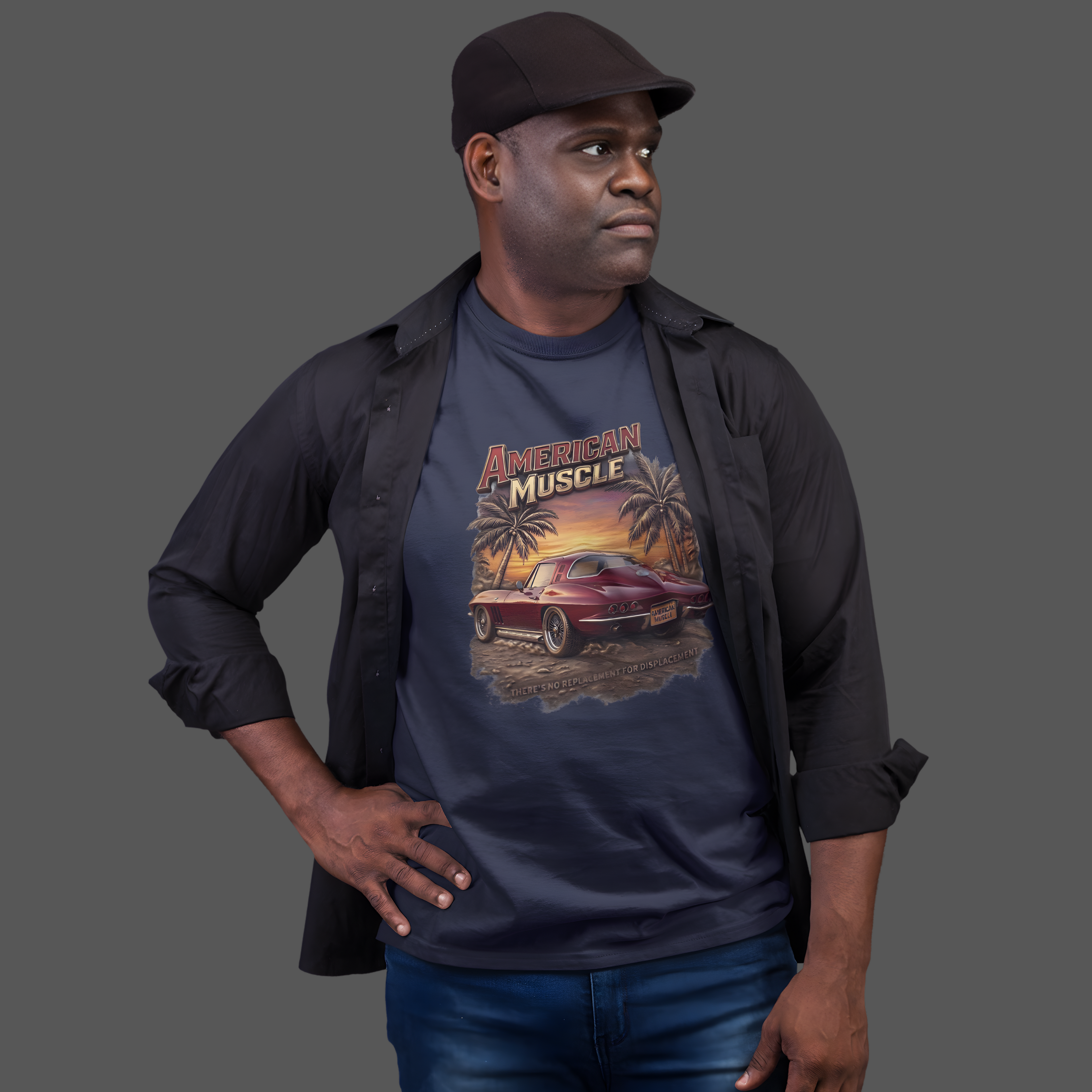 Man wearing a navy blue t-shirt with 'American Muscle' graphic design on a gray background