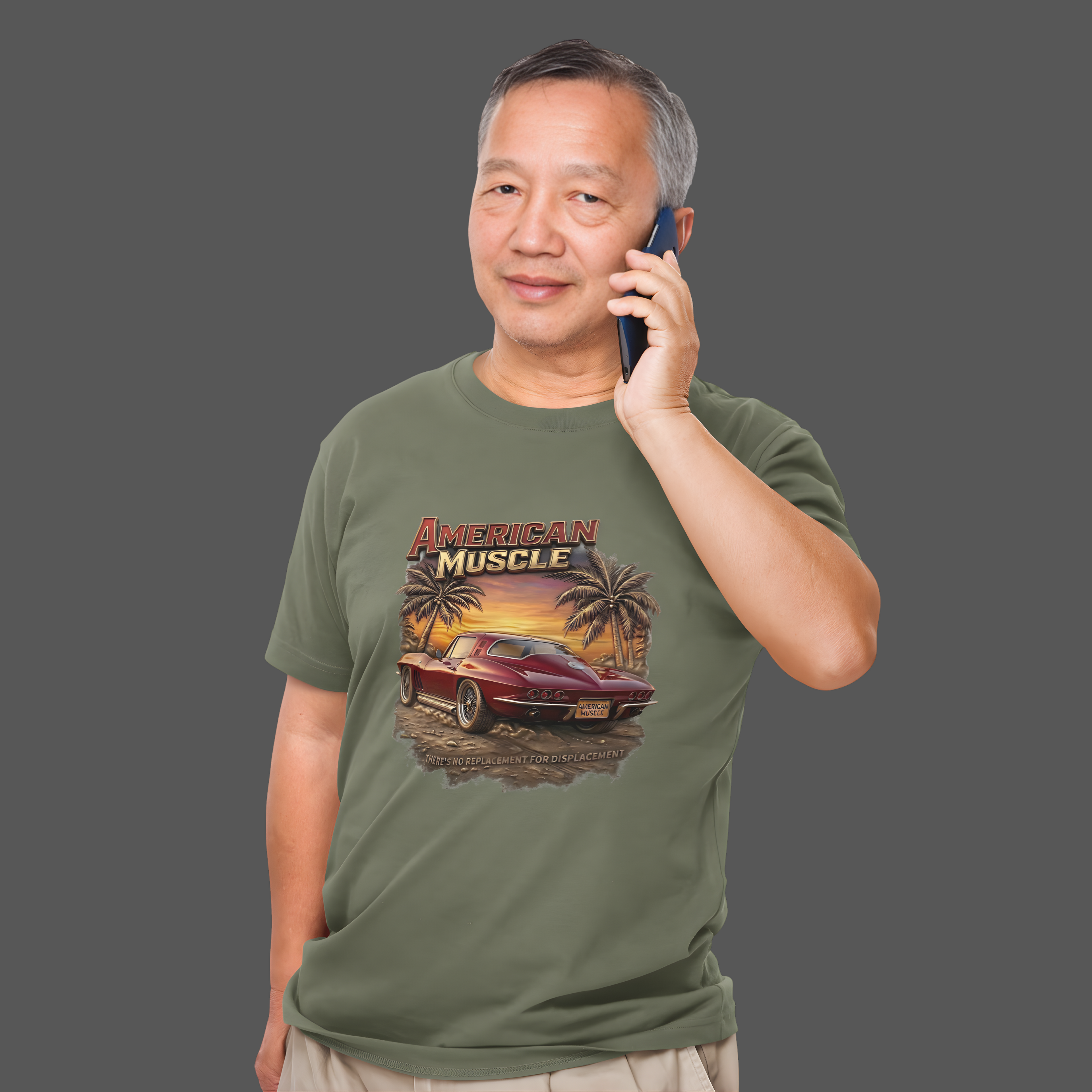 Man wearing a military green t-shirt with 'American Muscle' graphic design on a gray background