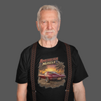 Man wearing a black t-shirt with 'American Muscle' graphic design on a gray background
