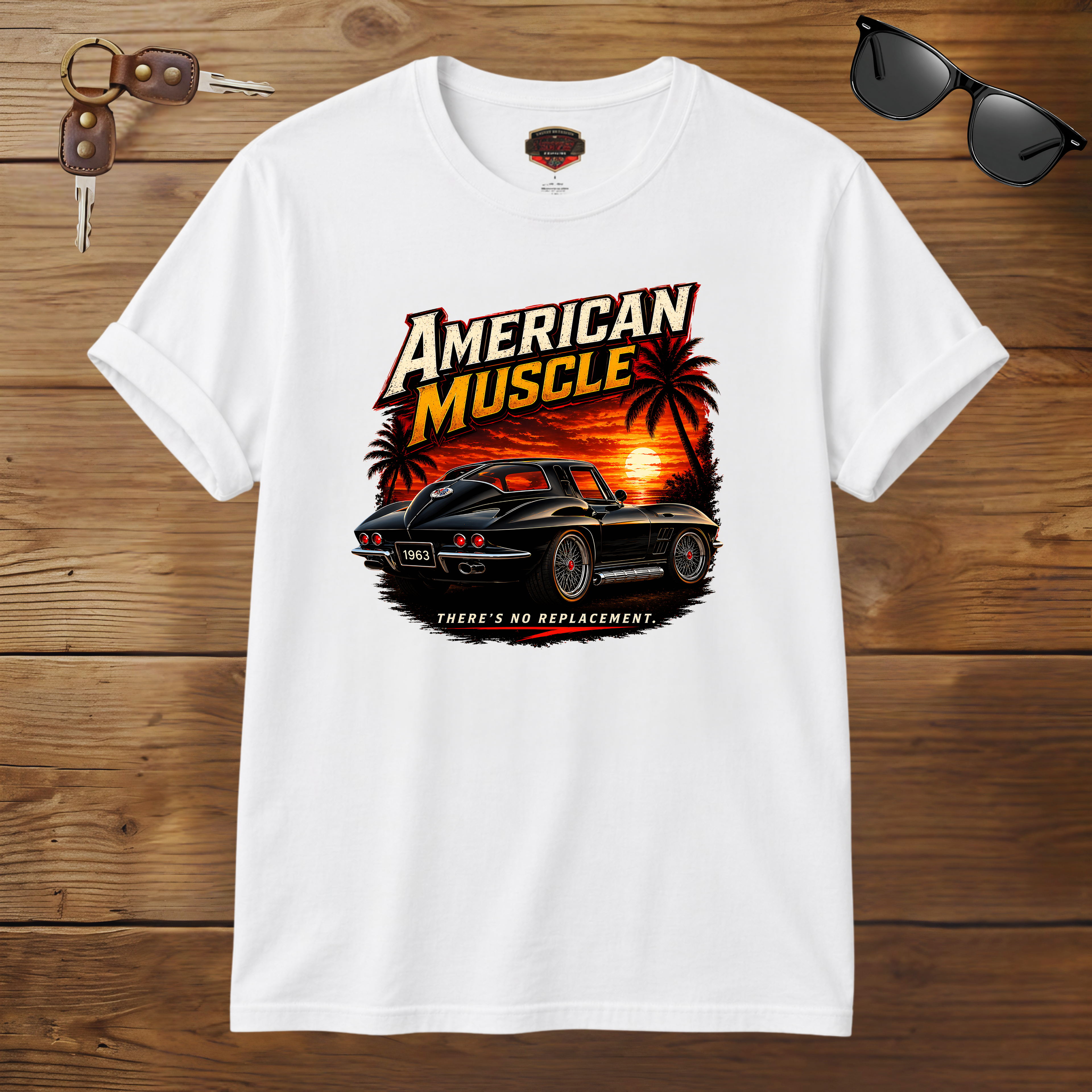 White t-shirt with 'American Muscle' graphic design on a wooden surface with sunglasses and car keys.