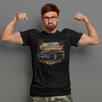 Man wearing a black t-shirt with a car graphic and text, flexing his muscles against a gray background