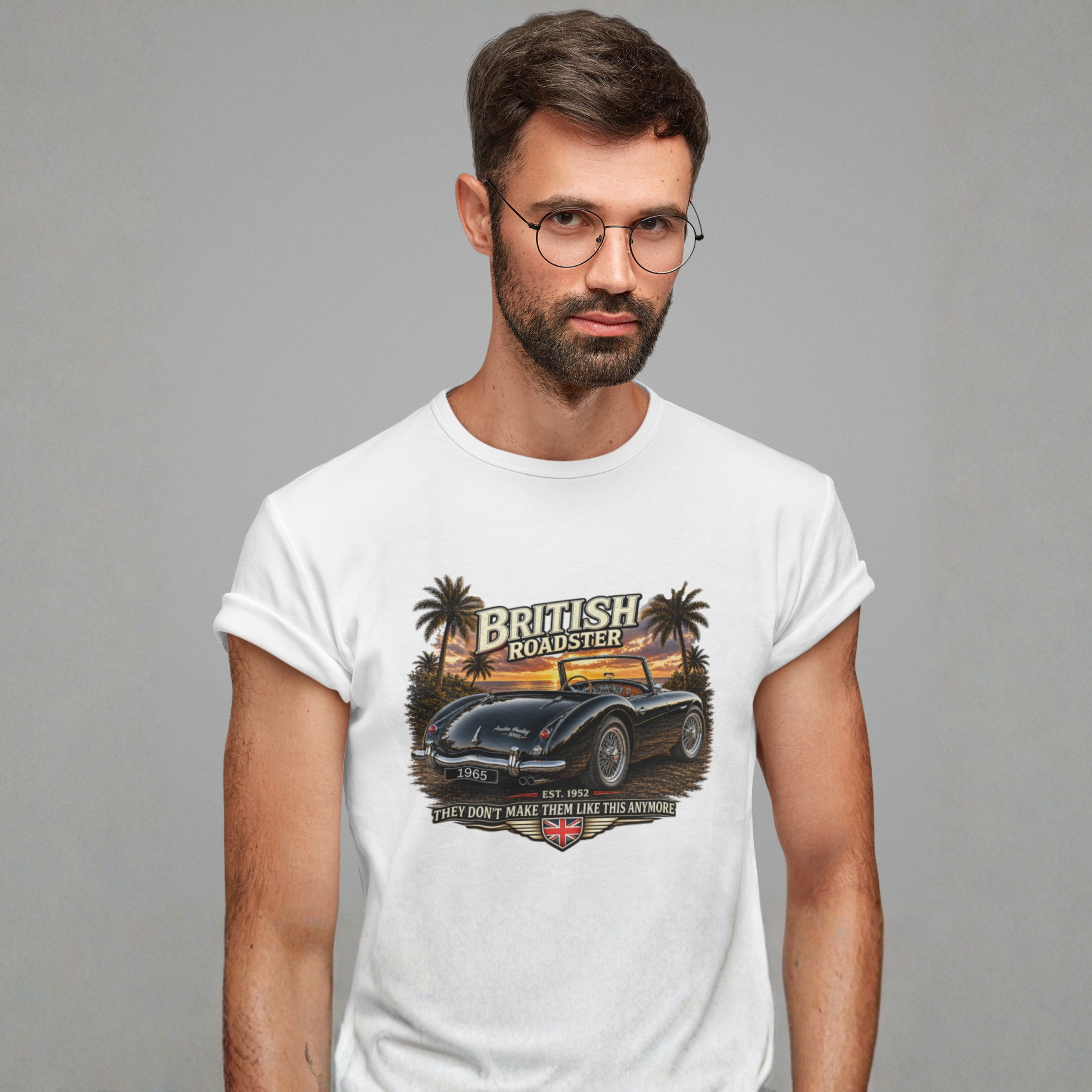 Man wearing a white t-shirt with a graphic design of a British roadster car on a gray background