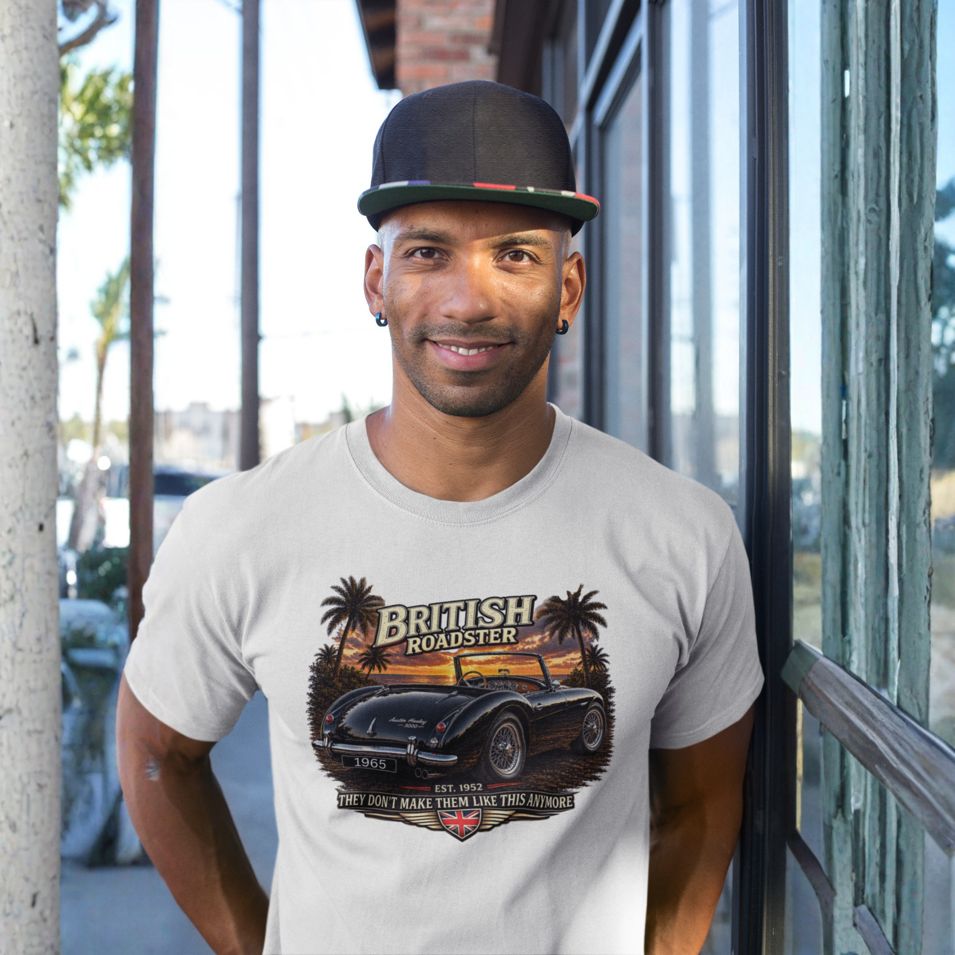 Man wearing a t-shirt with a graphic design of a British roadster car.