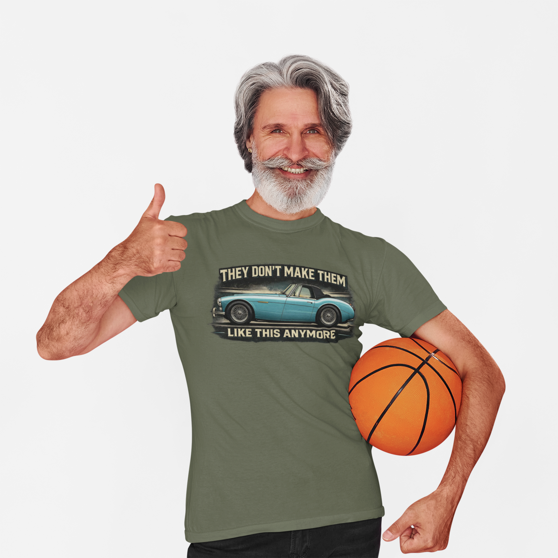 Man wearing a military green t-shirt with a Healey graphic and text, holding a basketball on a white background