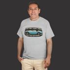 Man wearing a sport gray t-shirt with a Healey graphic design on a dark background