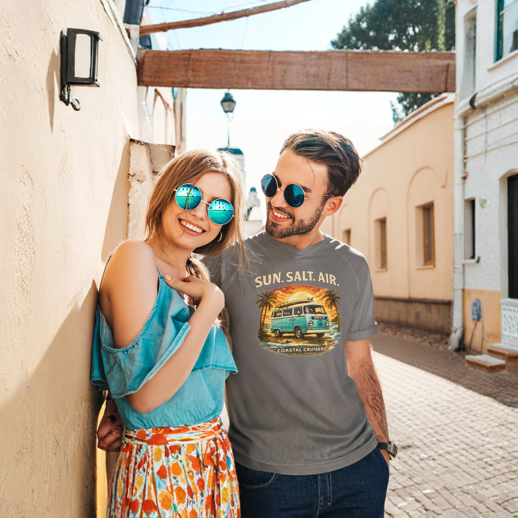 Two people standing together on a street, one wearing a t-shirt with a retro van graphic and text.