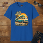 Royal blue t-shirt with a graphic design of a van and text 'Catch the Wave! Healey Threads' on a wooden surface.