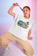 Woman wearing a white t-shirt with a graphic van design on a gradient background