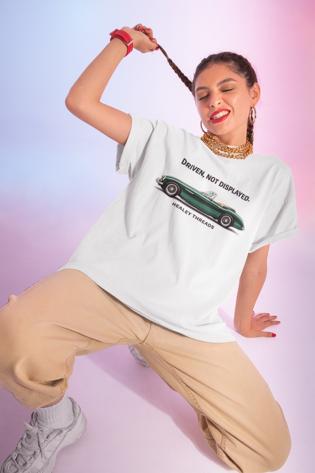 Woman wearing a white t-shirt with a classic car graphic design on a gradient background