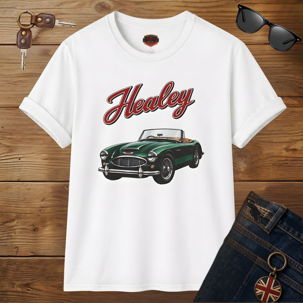 White t-shirt with green classic car graphic and 'Healey' text on a wooden surface with sunglasses and keys.