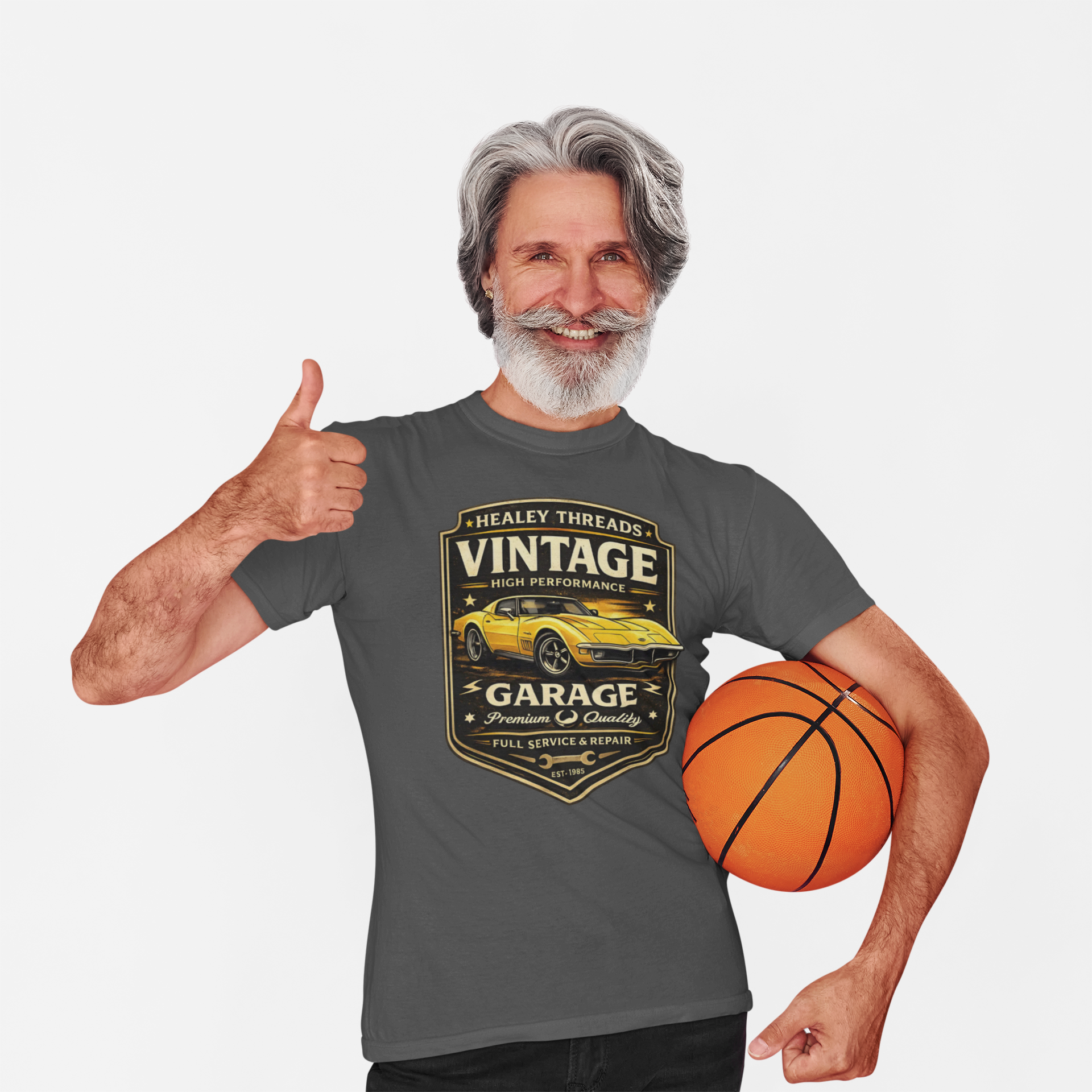 Man wearing a t-shirt with a vintage classic car  graphic, holding a basketball, and giving a thumbs-up.