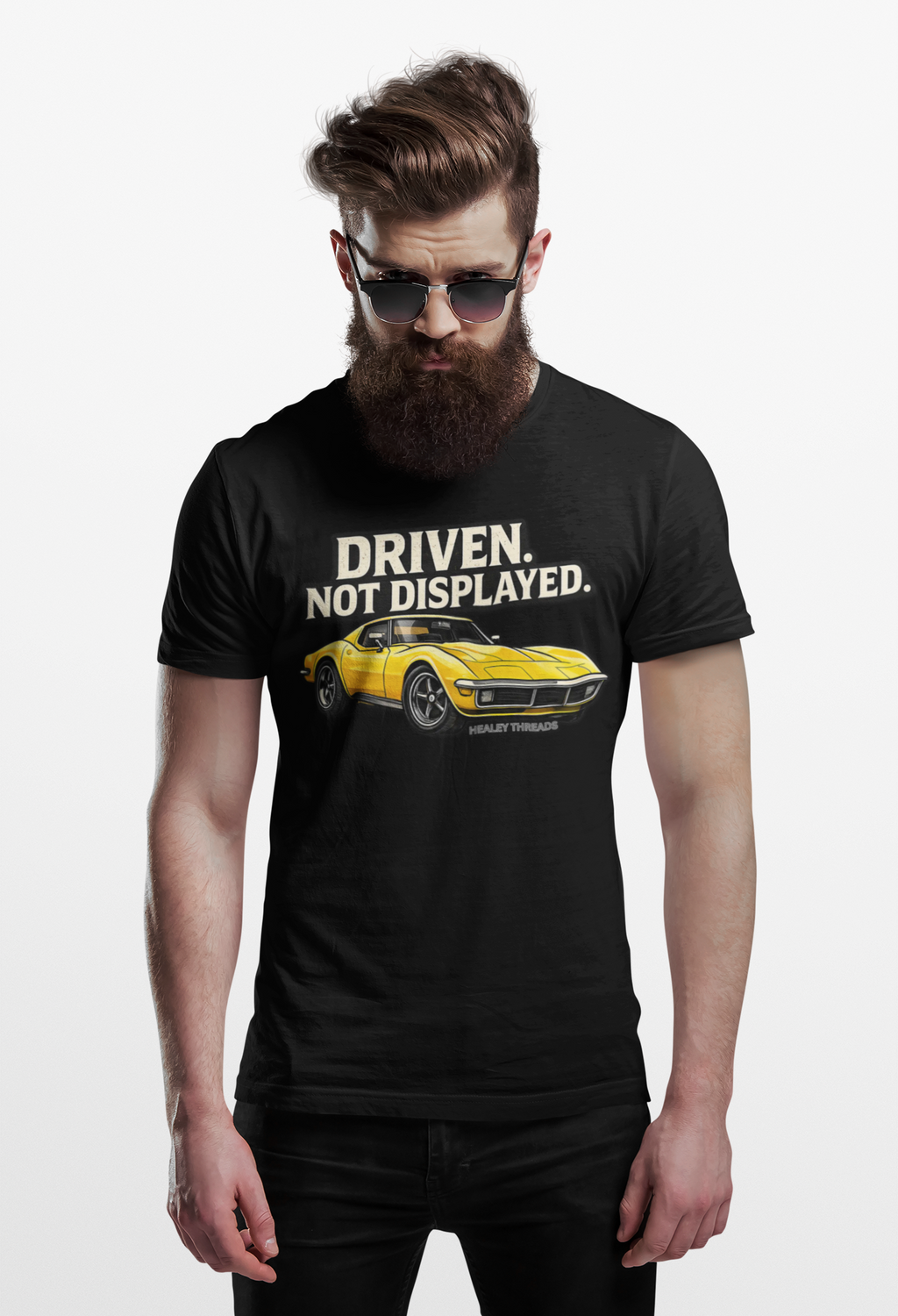 Man wearing a black t-shirt with a yellow muscle car graphic and text on a white background