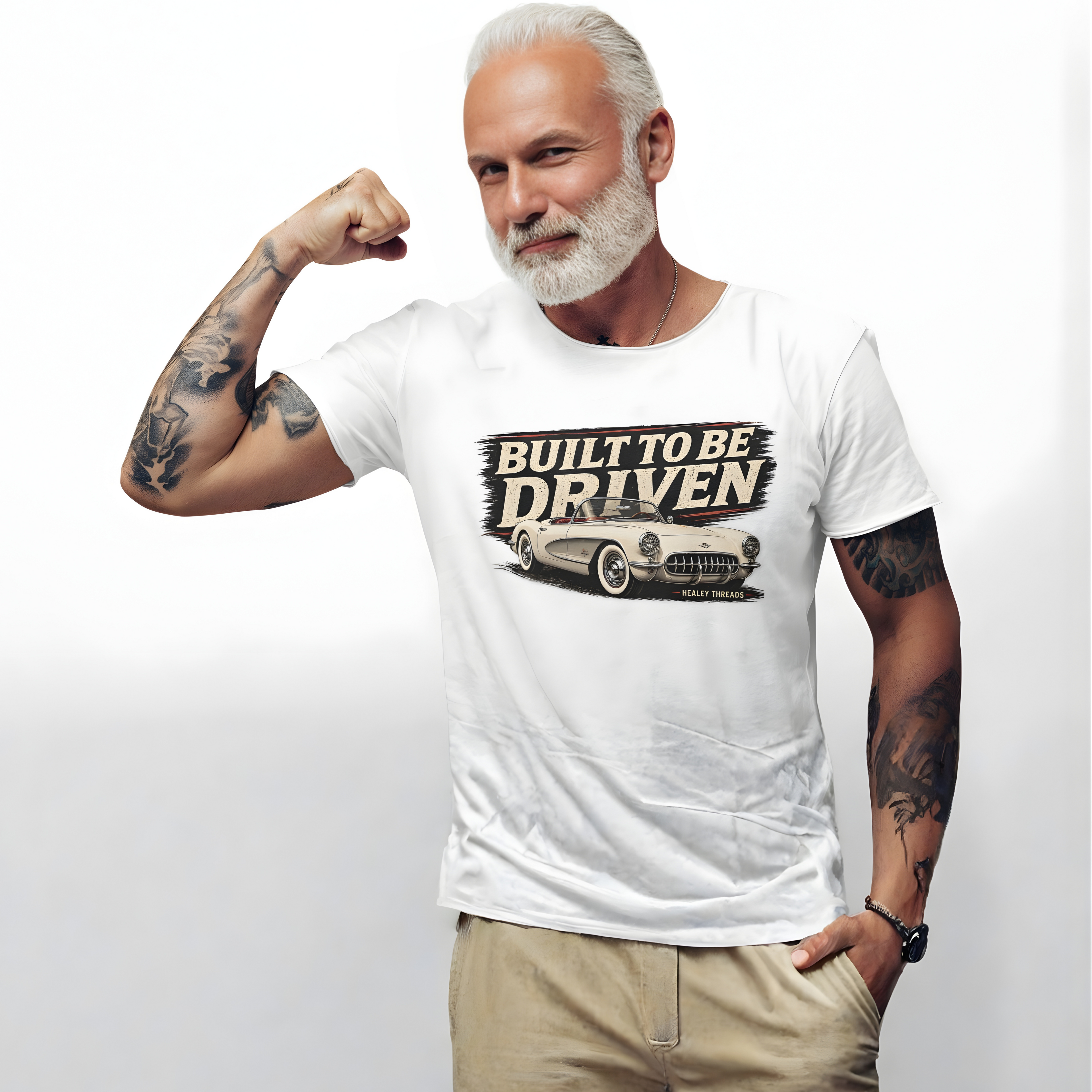Man wearing a white t-shirt with 'Built to be Driven' graphic on a plain background