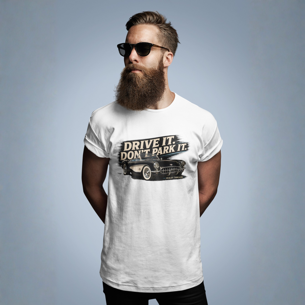 Man wearing a white t-shirt with a vintage car graphic design and text against a gray background