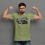 Man wearing a military green t-shirt with a vintage car graphic and text, flexing his muscles against a gray background