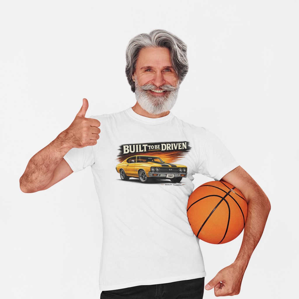 Man wearing a white t-shirt with a car graphic and text, holding a basketball, on a white background