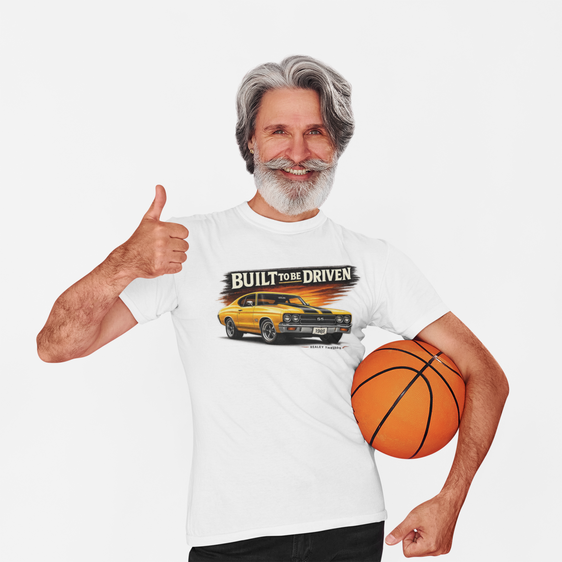 Man wearing a white t-shirt with a car graphic and text, holding a basketball, on a white background
