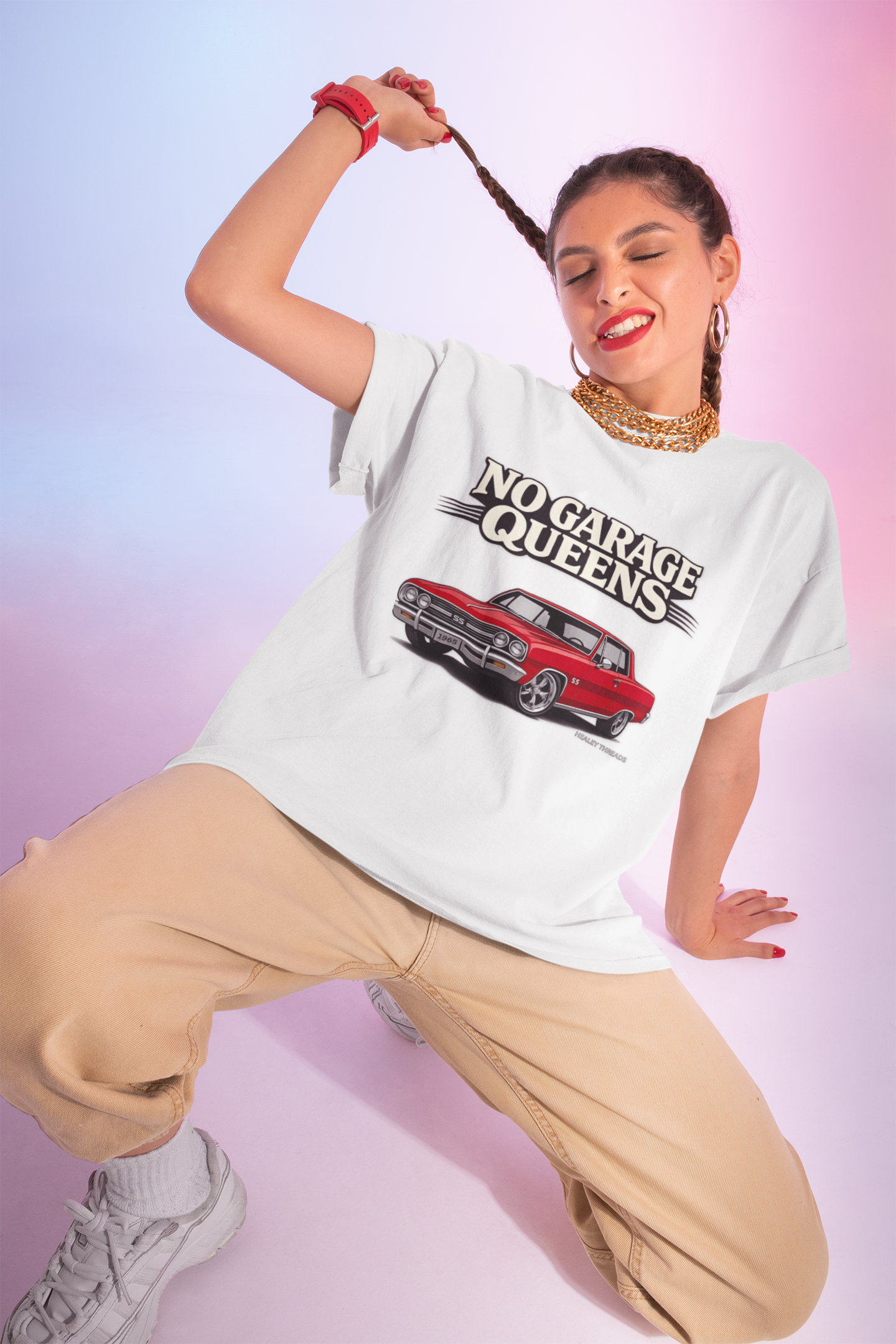 Woman wearing a white t-shirt with 'No Garage Queens' text and car graphic on a gradient background