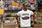 Man wearing a white t-shirt with 'No Garage Queens' graphic in a music store.