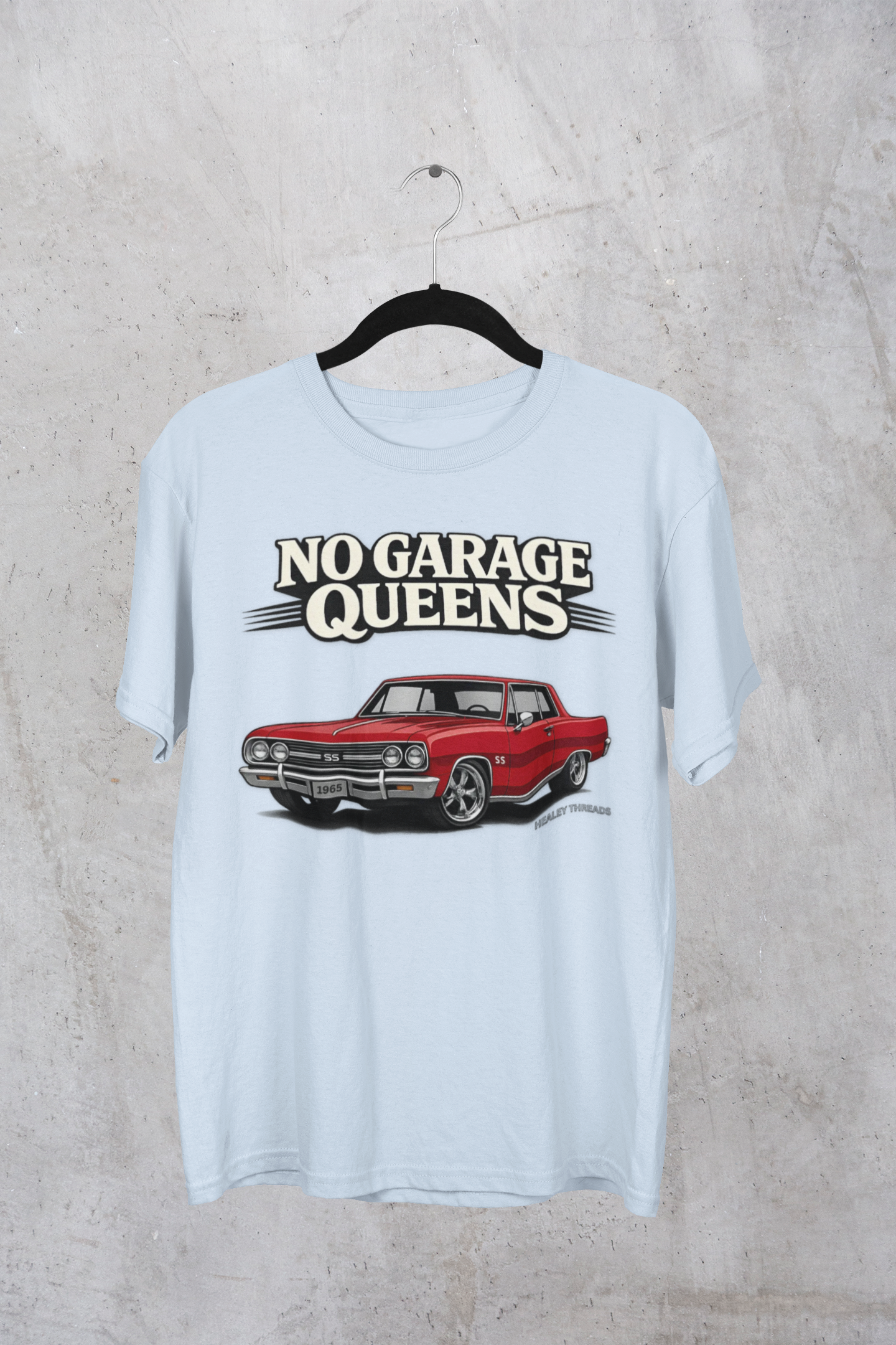 Light blue t-shirt with red car graphic and 'No Garage Queens' text on a textured gray background