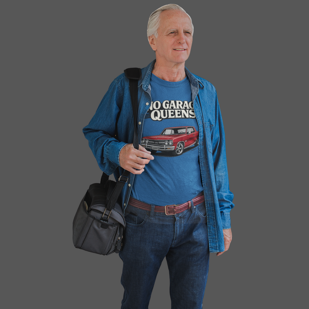 Man wearing a royal blue t-shirt with a graphic design, holding a black bag on a gray background