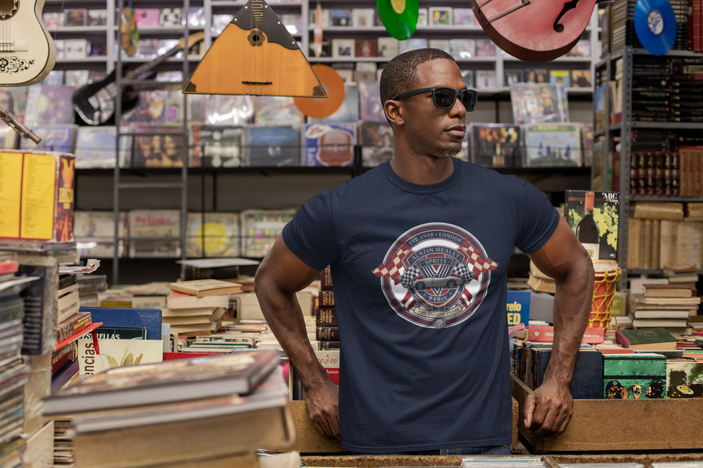 Man wearing a navy blue t-shirt with a graphic Healey Sprite design in a music store.