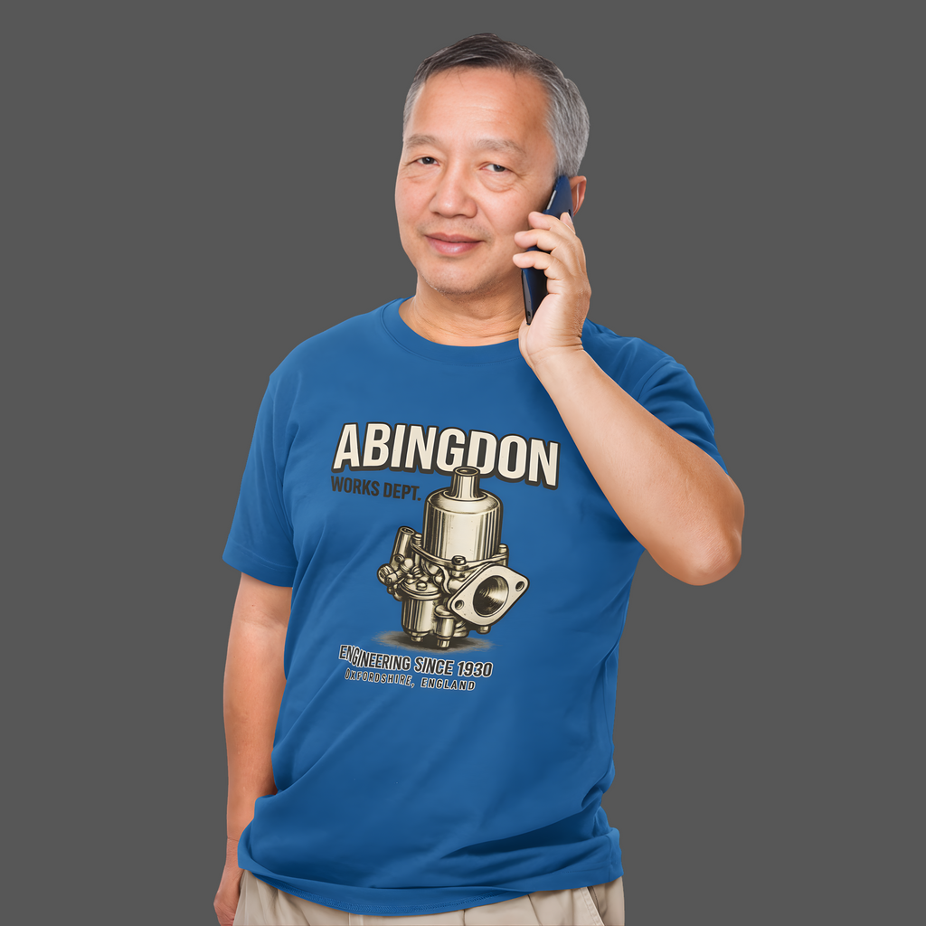 Man wearing a royal blue t-shirt with 'Abingdon' design and text, talking on a phone.