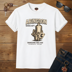 White t-shirt with mechanical design and text on a wooden surface