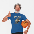 Man wearing a royal blue t-shirt with a Lucas Electrical Works graphic and holding a basketball, giving a thumbs up.