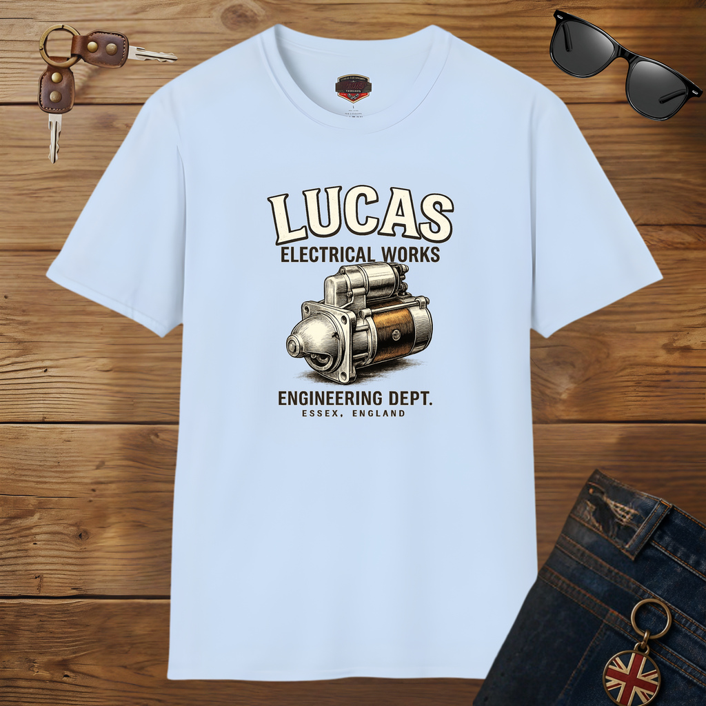 Light blue t-shirt with Lucas Electrical Works graphic on a wooden surface with sunglasses and keys.