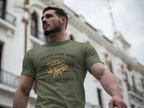 Man wearing a military green t-shirt with 'Coventry Engine Works' text and logo, standing in front of a building.