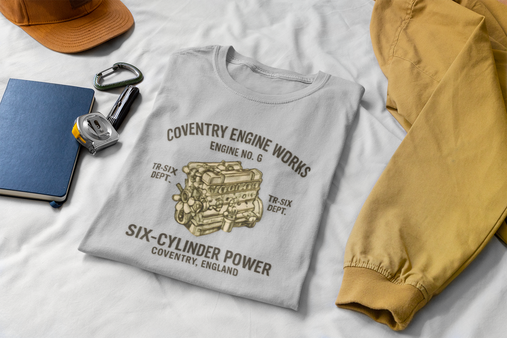 Sport gray t-shirt with 'Coventry Engine Works'  design and text on a white surface with tan jacket and a cap.