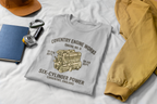 Sport gray t-shirt with 'Coventry Engine Works'  design and text on a white surface with tan jacket and a cap.
