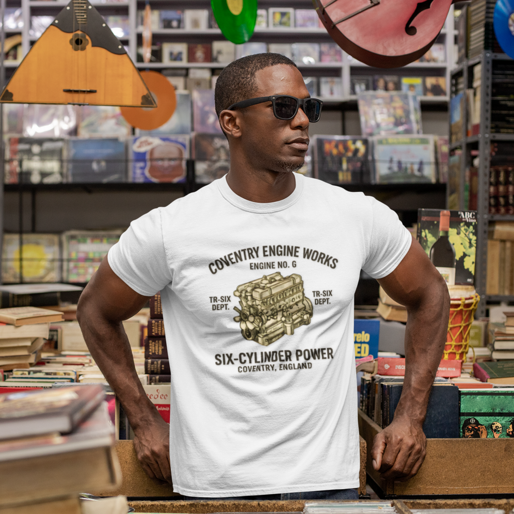 Man wearing a white t-shirt with a graphic 'Coventry Engine Works' design in a record store.